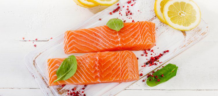 Fresh salmon fillet with herbs, spices and lemon